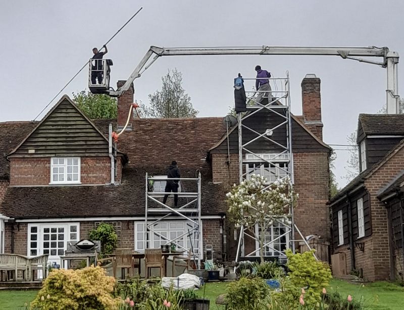 The Roof Moss Cleaners using cherry picker and scaffolding to clean roof safely and professionally in Eaton Bray, Bedfordshire
